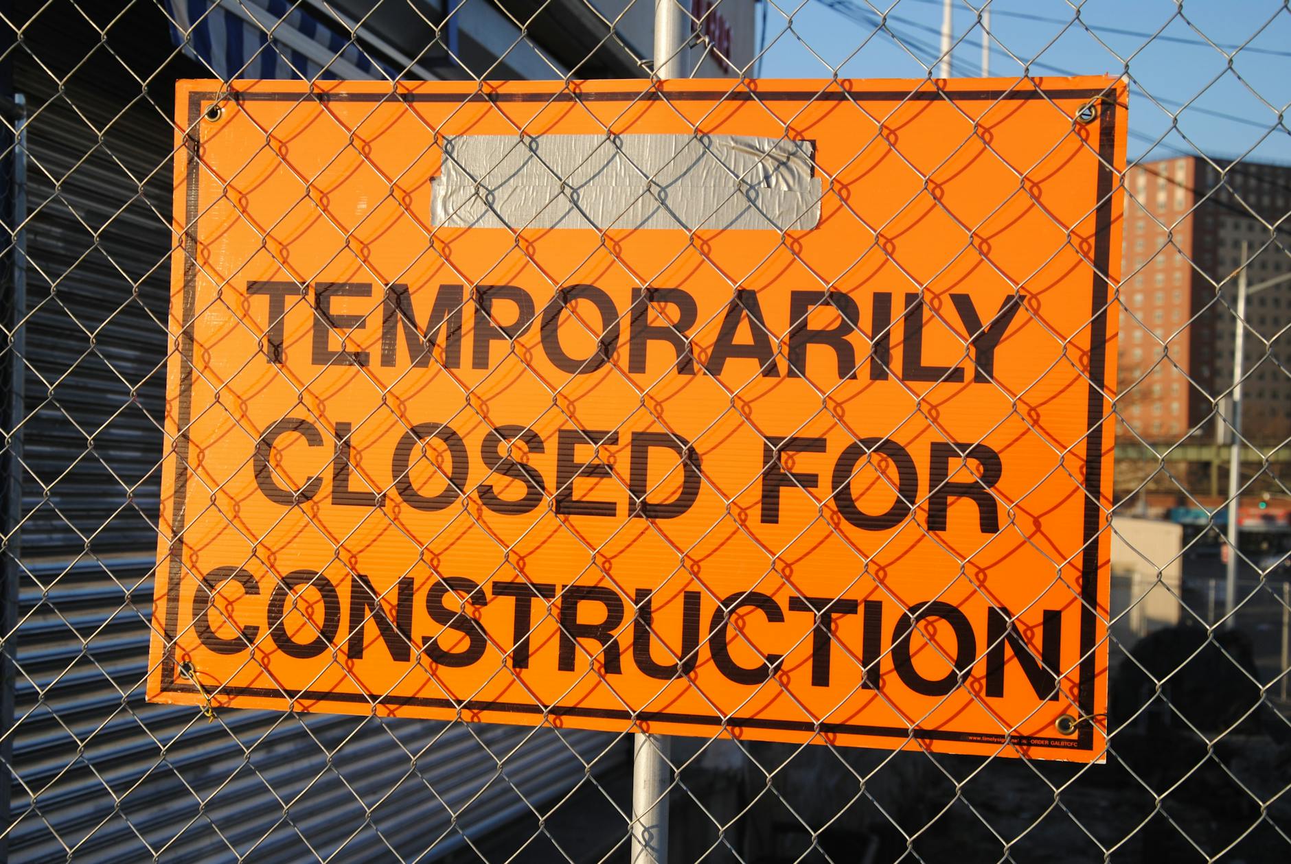 orange and black temporarily closed for construction signage